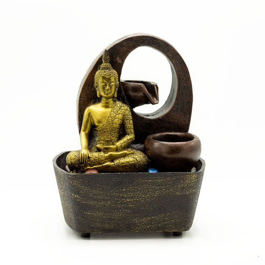 Golden Buddha statue seated in a dark bowl with water cascading into tiered pots, a serene tabletop fountain.
