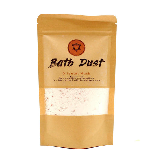 Fine pink bath dust powder in a clear glass jar with a wooden spoon, perfect for a relaxing soak.