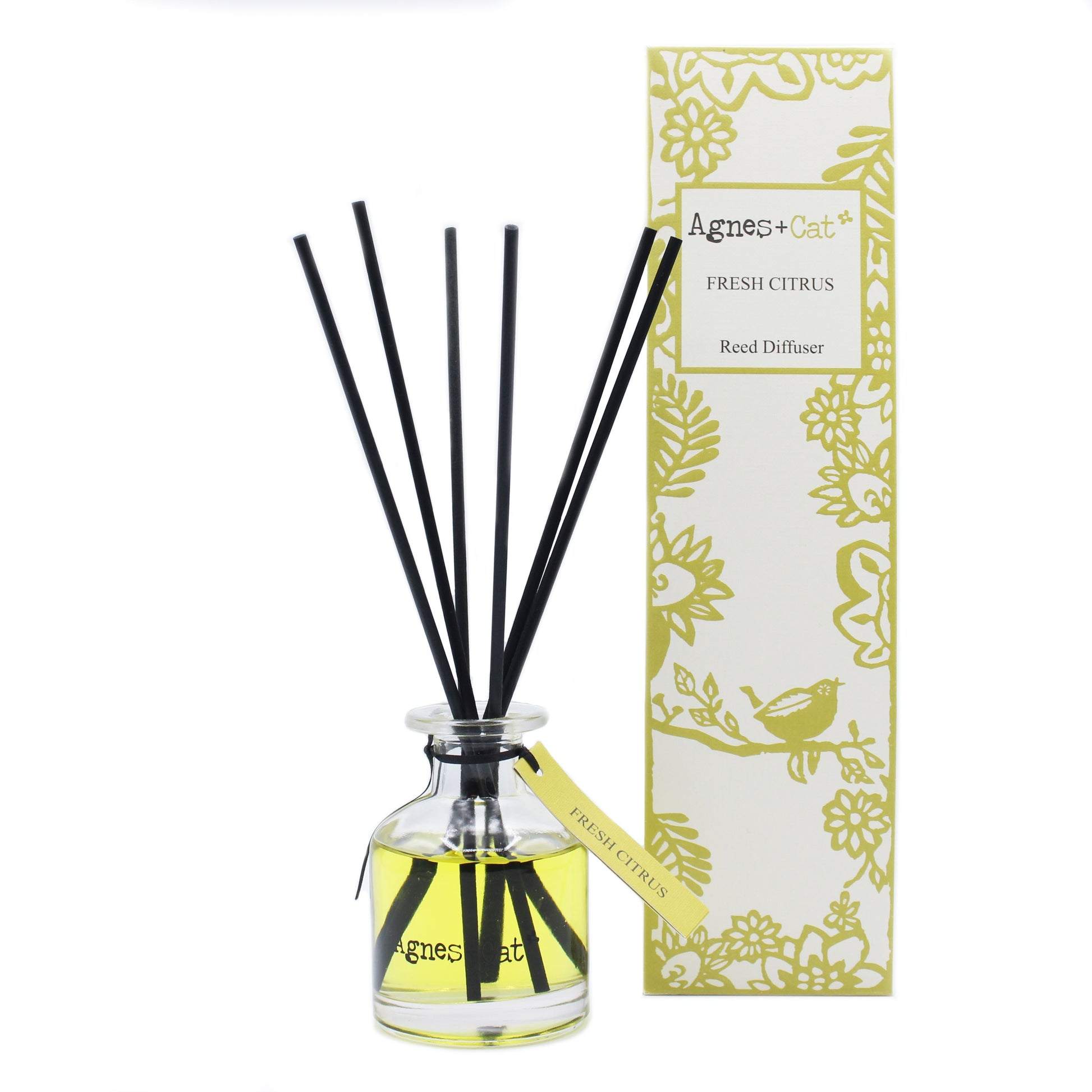 Clear glass reed diffuser bottle with 140ml of citrus-scented oil and natural wooden reeds on a neutral background.