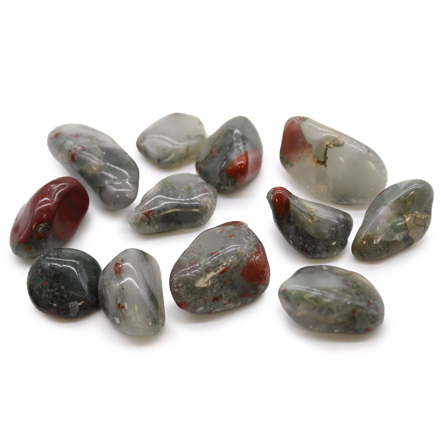 Smooth, polished dark green tumble stones with vibrant red and earthy inclusions, known as African Bloodstone.