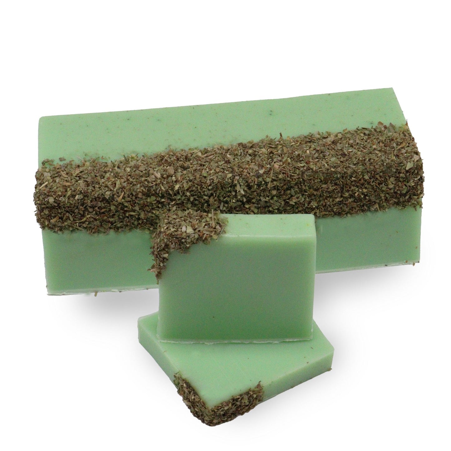 Handcrafted herbal soap loaf with a textured green and cream surface, infused with green tea and olive.