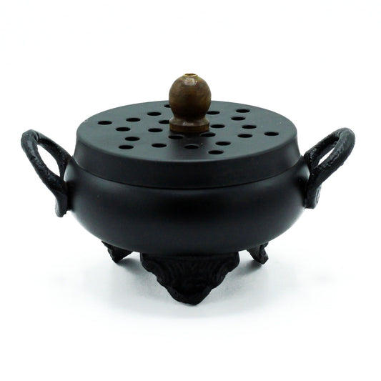 Rustic black cast iron cauldron incense burner with a traditional three-legged design and side handles.