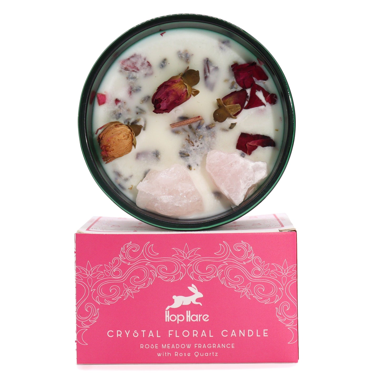 A decorative soy wax candle topped with rose quartz crystals and delicate pink dried rose petals in a glass jar.