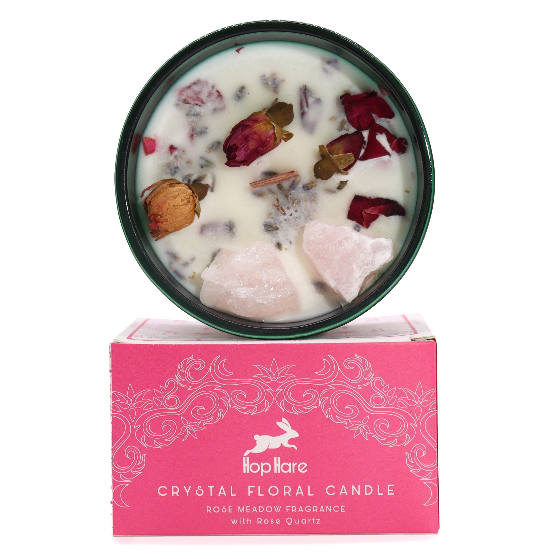 A decorative soy wax candle topped with rose quartz crystals and delicate pink dried rose petals in a glass jar.