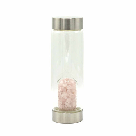 Clear glass water bottle filled with light pink rose quartz crystal chips at the base.