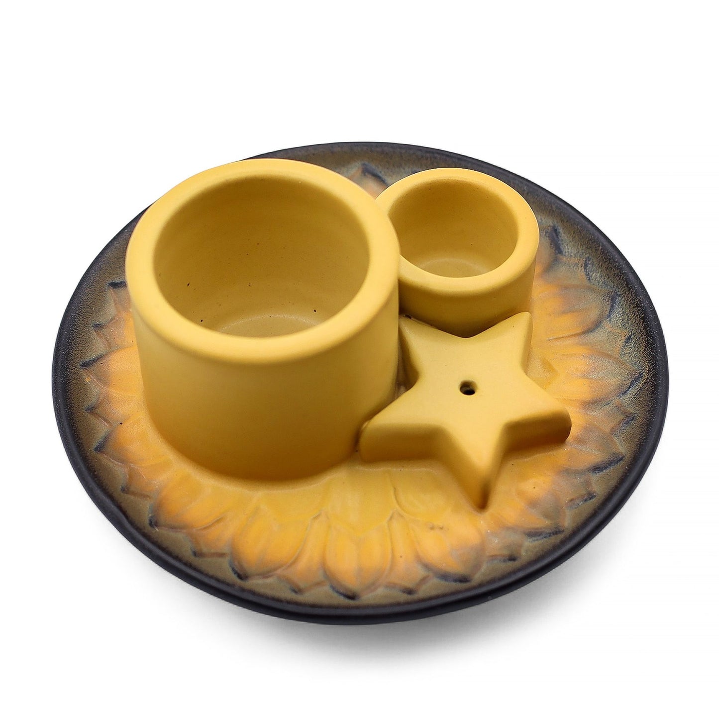 Ceramic circular smudge holder with a mandala design and a speckled sand and grey finish.