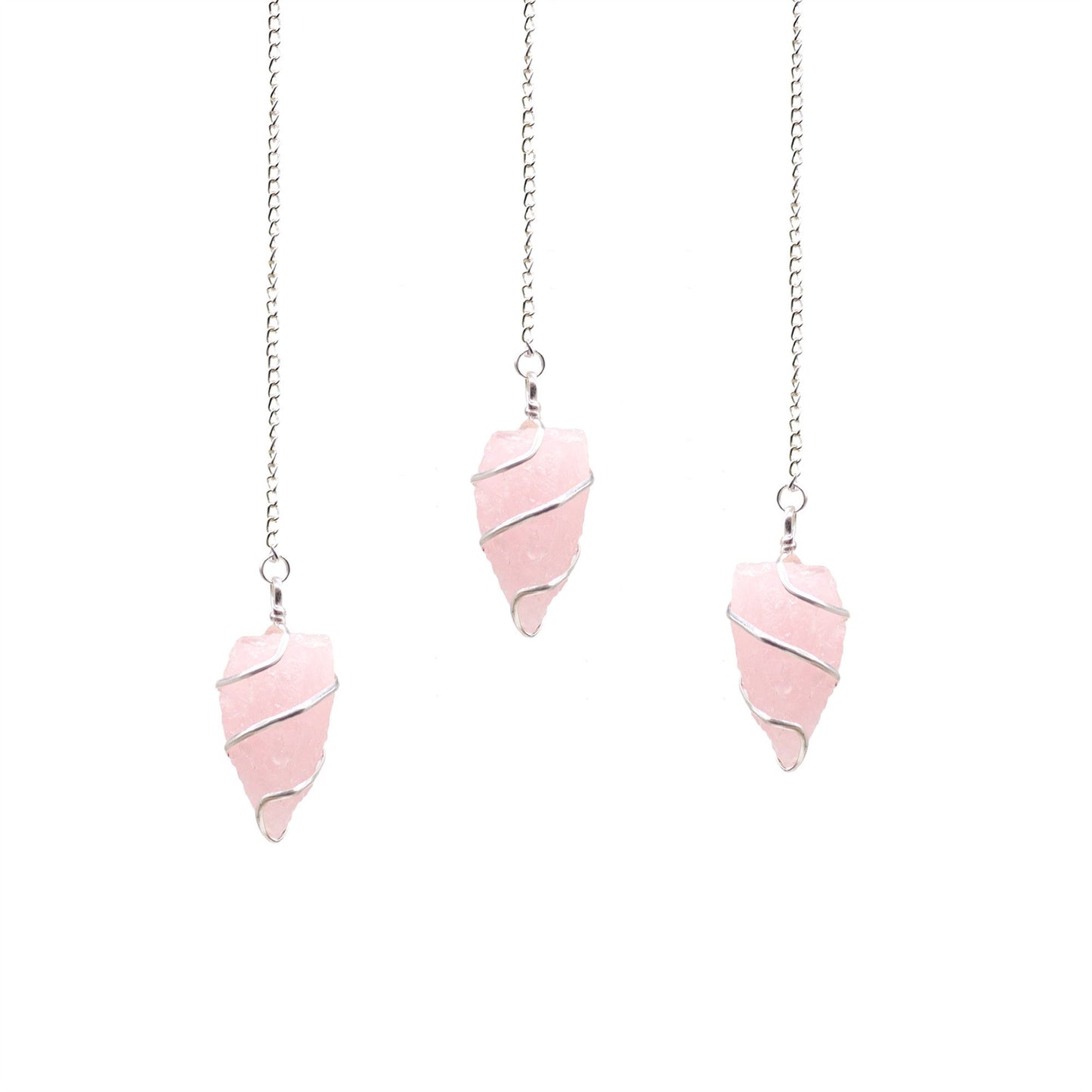 Uncut natural rose quartz gemstone pendulum with a delicate silver chain against a neutral background.