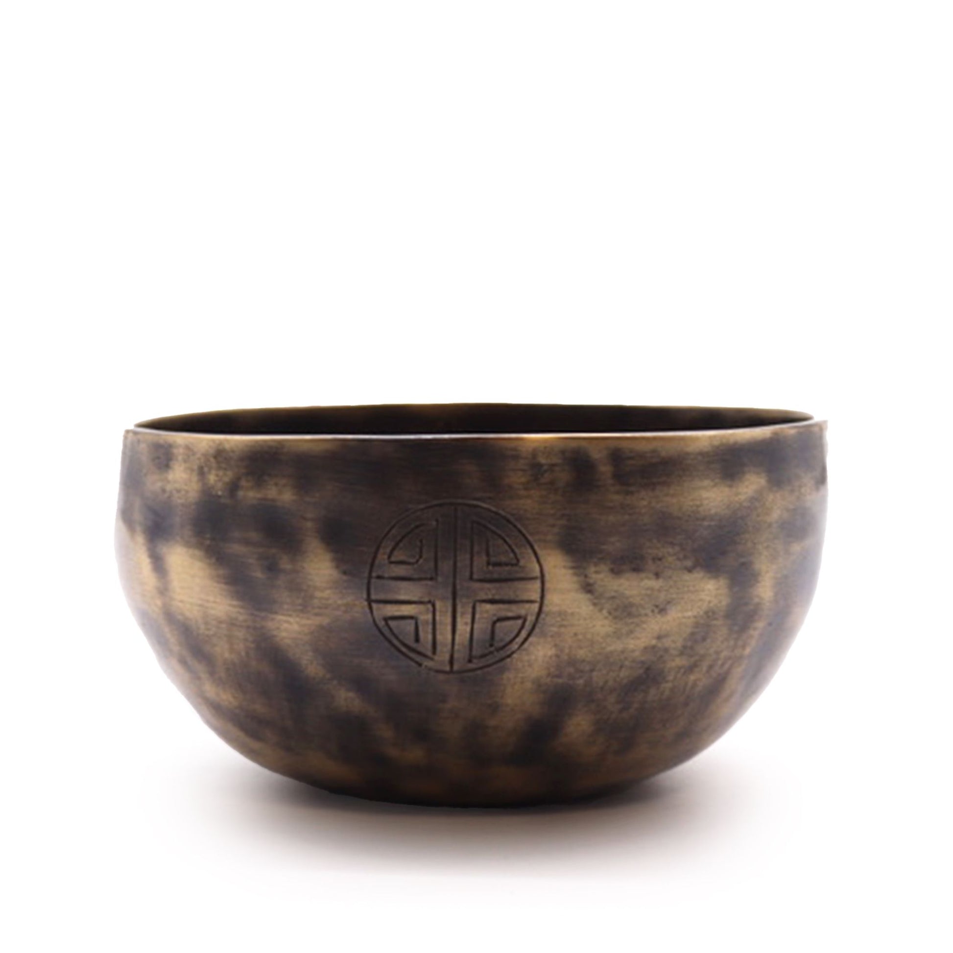 Handcrafted brass singing bowl with etched moon phase symbols around the outer rim and a wooden striker.