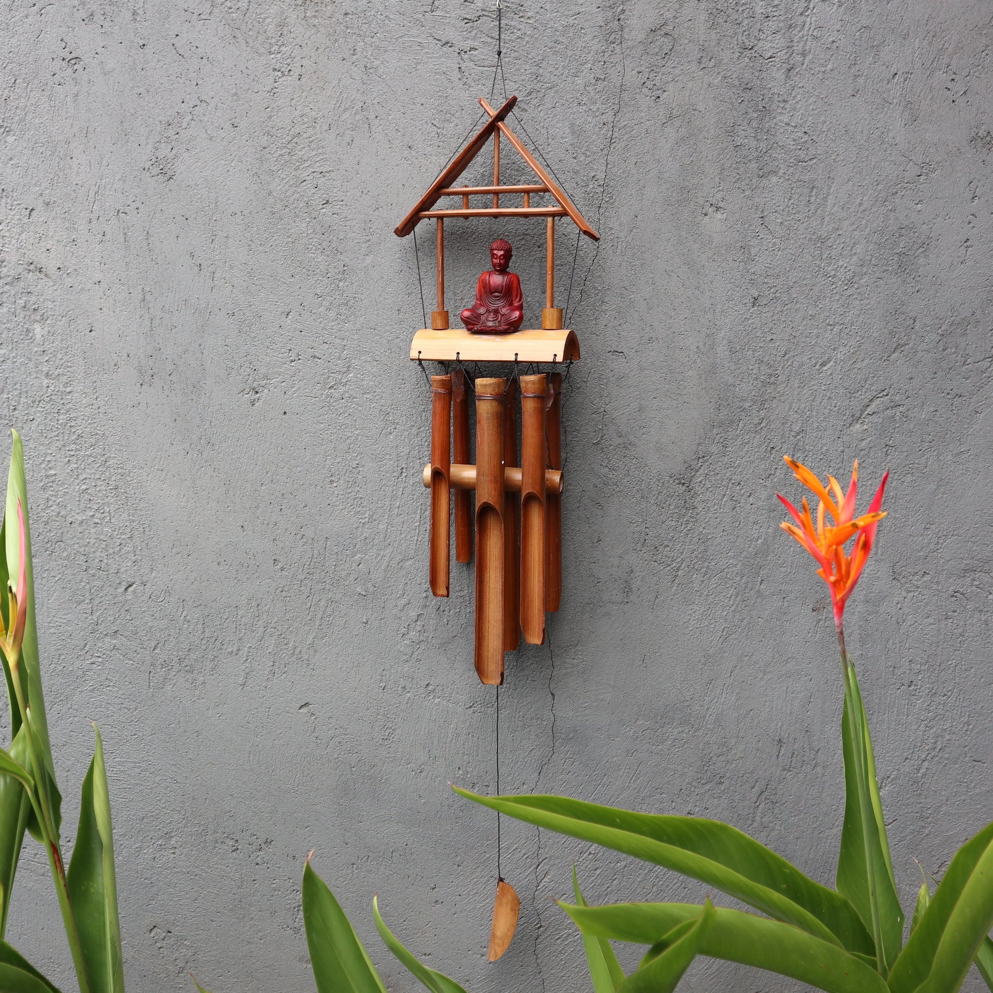 Handcrafted natural bamboo windchime with a brown Buddha motif and six melodic wooden tubes.