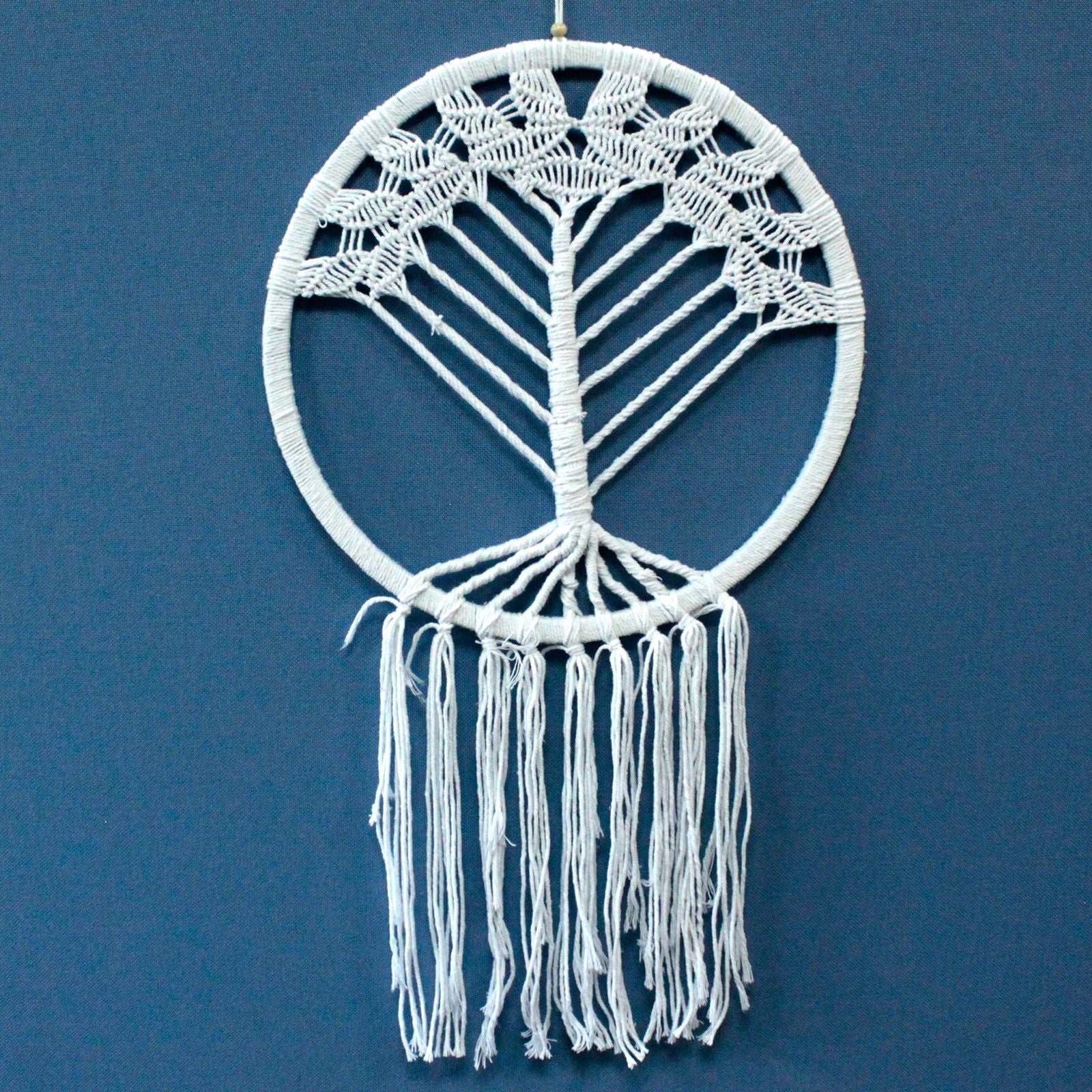Large intricate macrame dreamcatcher featuring a woven Tree of Life design in a bohemian style with long hanging tassels.