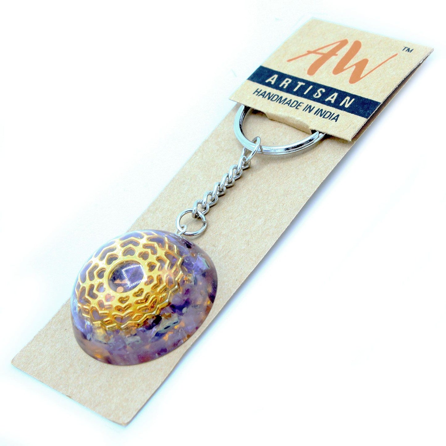 Circular orgonite keyring featuring purple amethyst gemstone chips, a copper spiral, and a geometric mandala heart design.