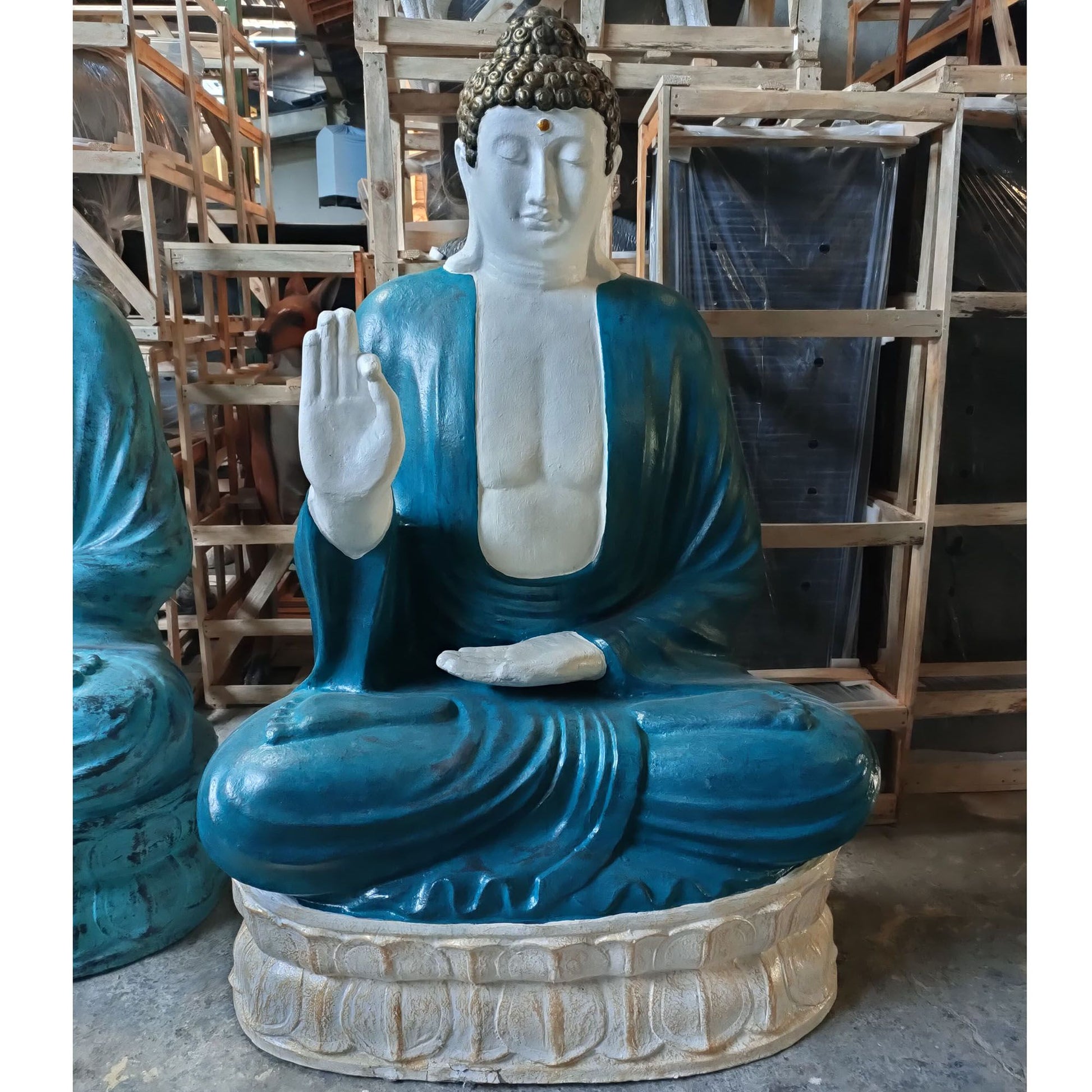 Large Thai Buddha statue with detailed turquoise and stone finish in a meditative pose.