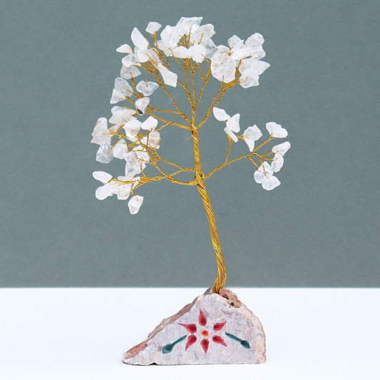 Handmade gemstone tree featuring clear rock crystal stones on flexible wire branches mounted on a natural mineral base.