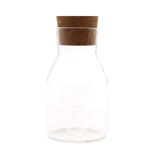Clear cylindrical glass jar with a natural cork stopper lid in a simple cottage style.