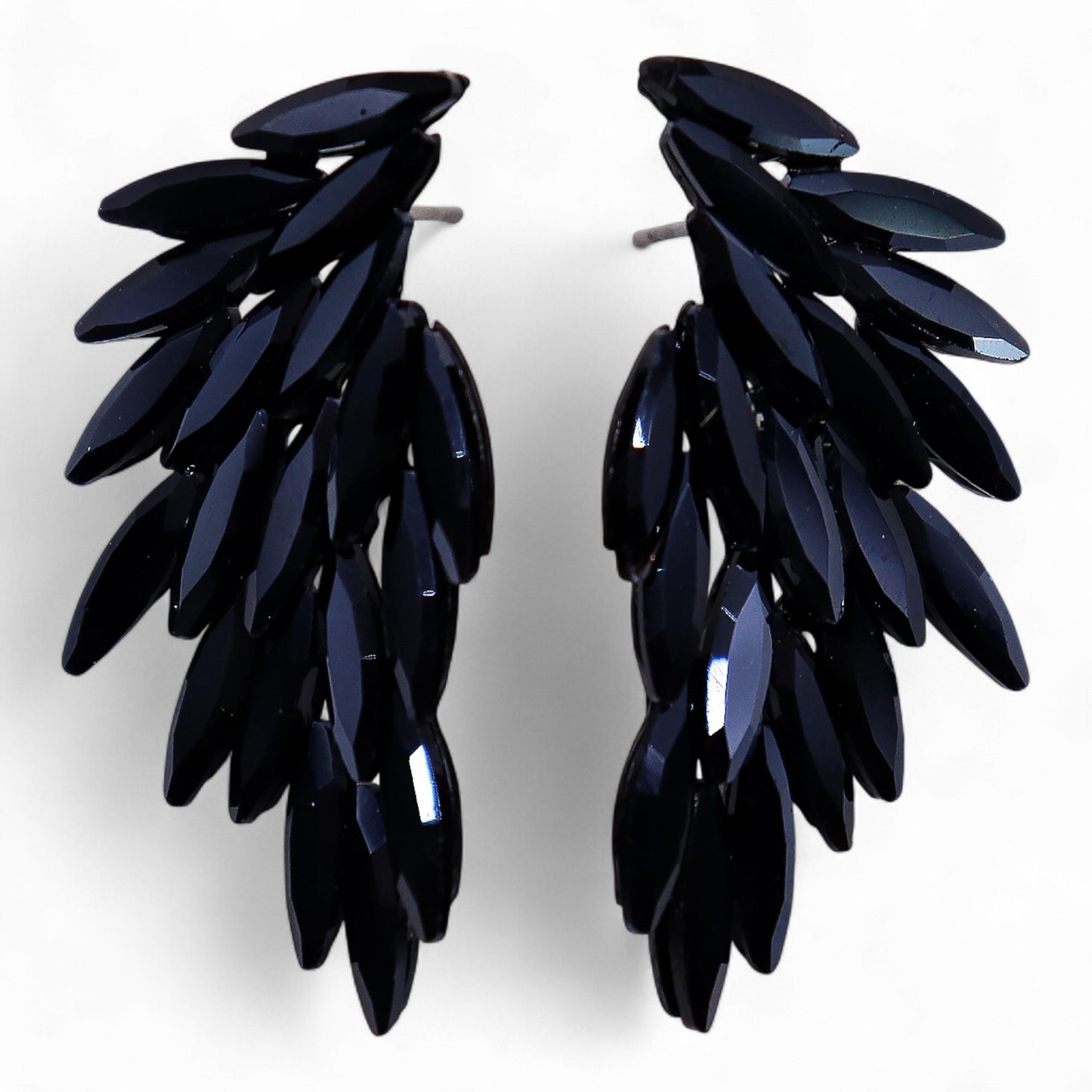 Jet black vintage glass earrings featuring detailed stainless steel angel wings on a dark backdrop.