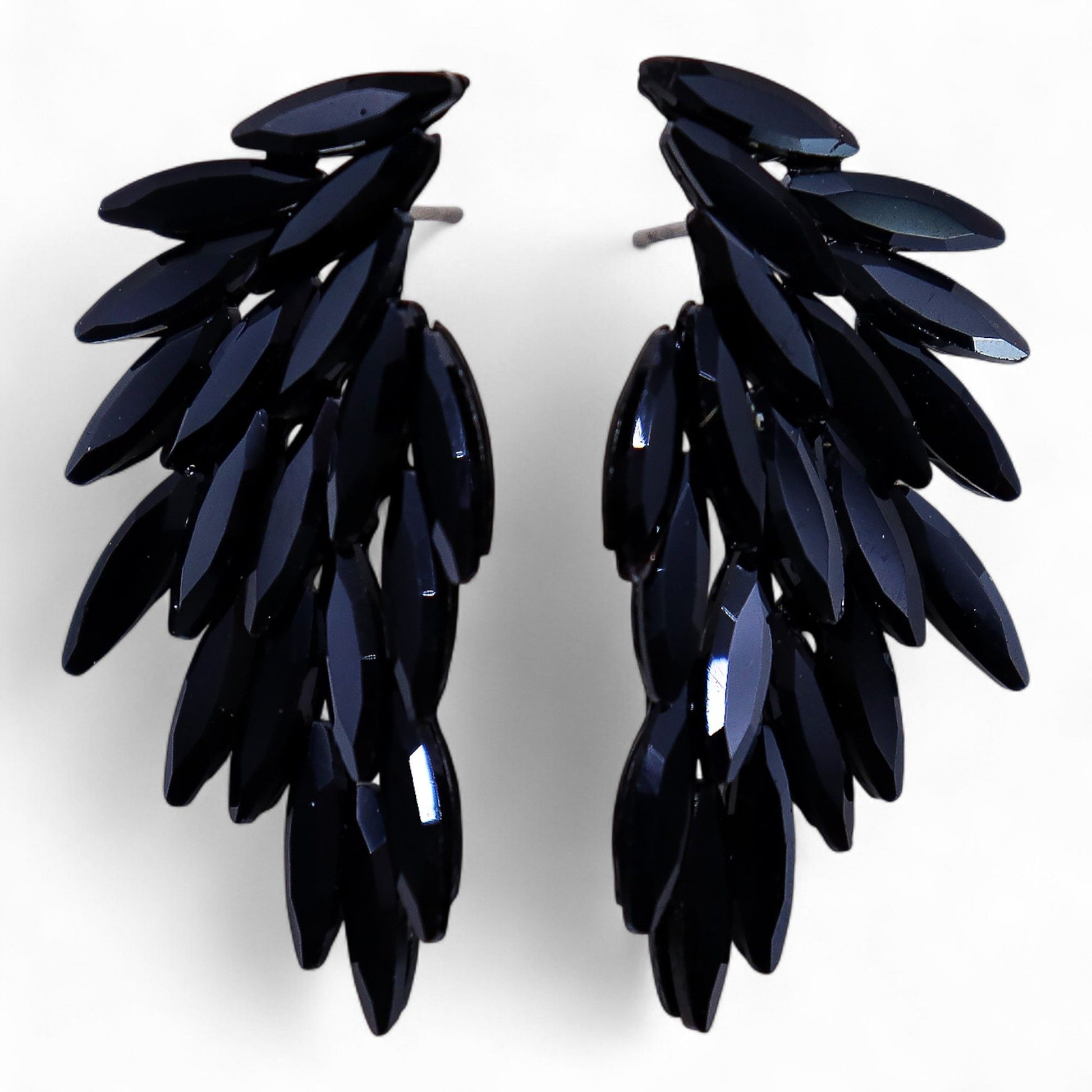 Jet black vintage glass earrings featuring detailed stainless steel angel wings on a dark backdrop.