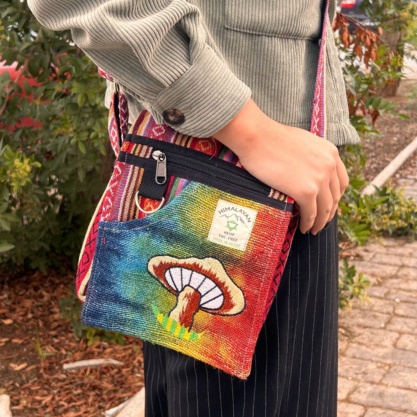 Small hemp fabric bag featuring detailed orange mushroom embroidery and a convenient shoulder strap.