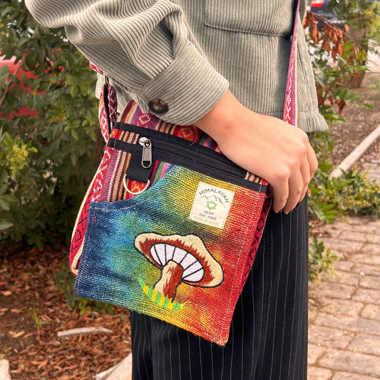 Small hemp fabric bag featuring detailed orange mushroom embroidery and a convenient shoulder strap.