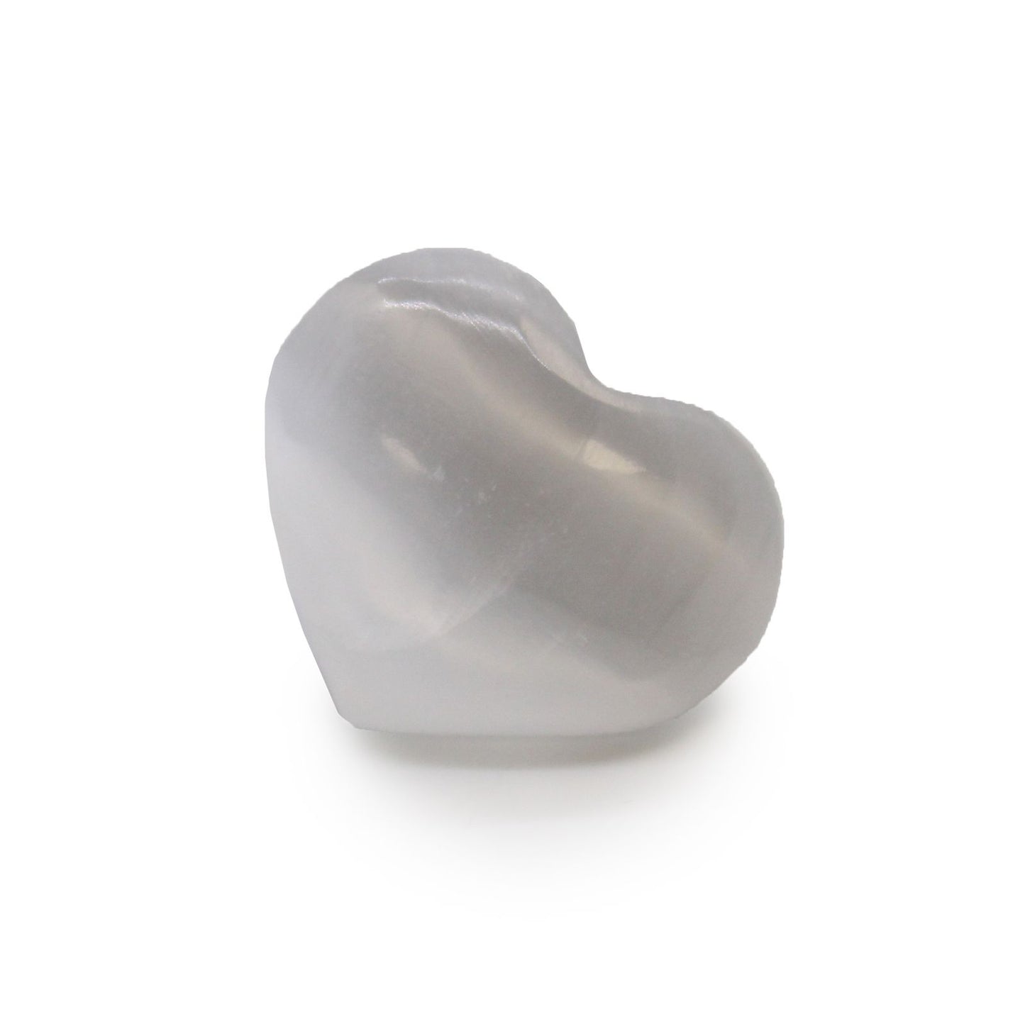 A small, smooth, translucent white selenite crystal carved into a heart shape.