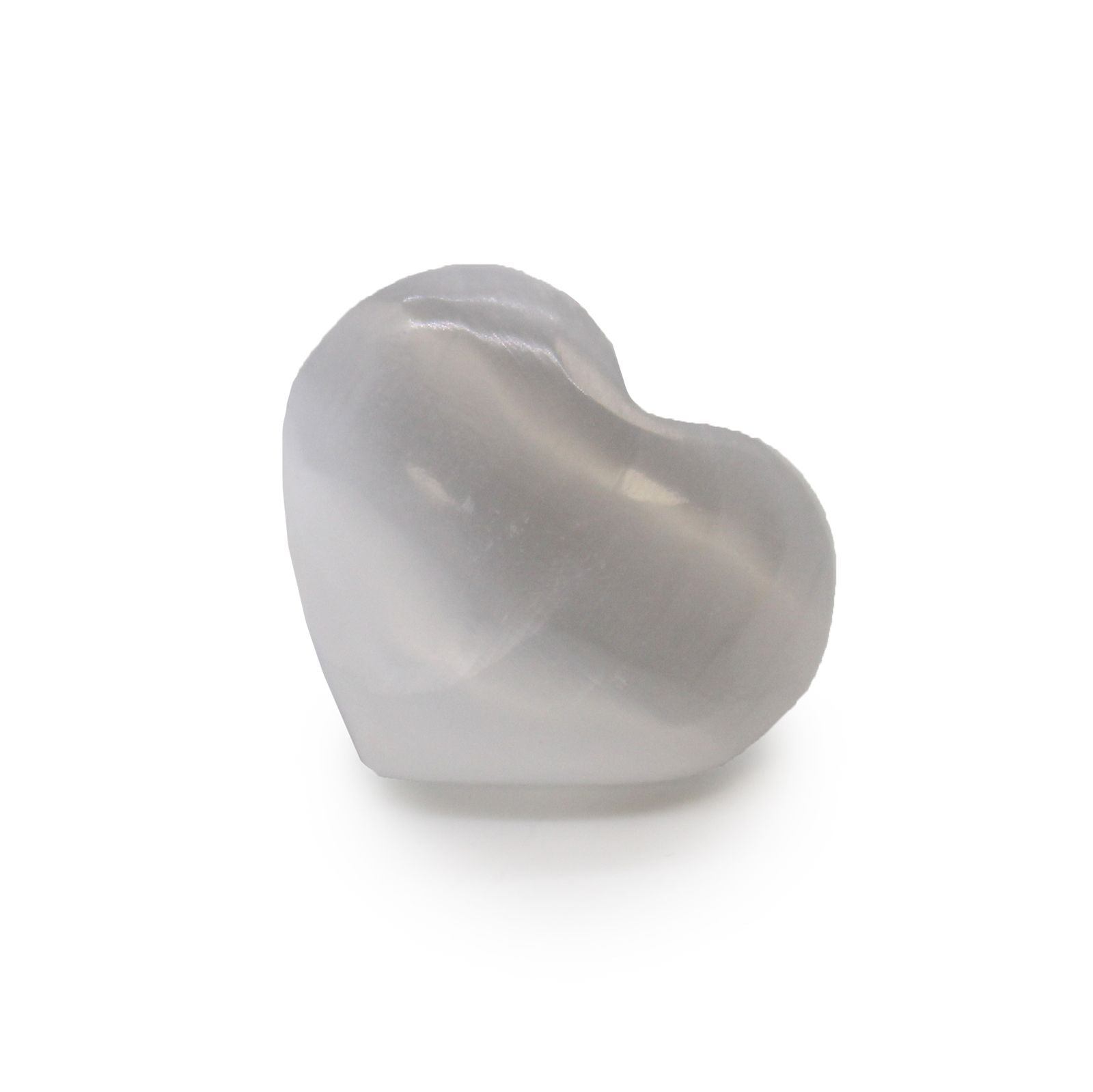 A small, smooth, translucent white selenite crystal carved into a heart shape.
