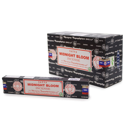 Hand-rolled incense sticks in a blue box with floral designs, releasing a thin stream of aromatic smoke.