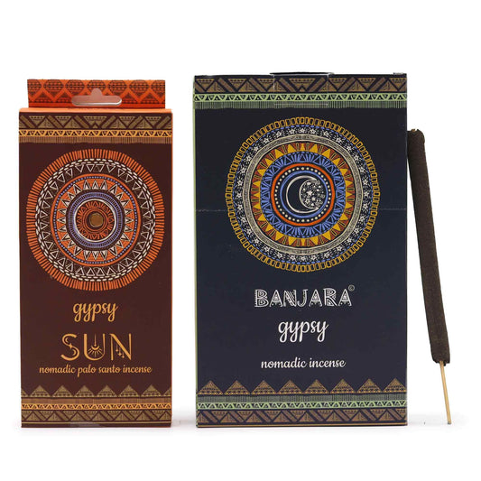 Hand-rolled incense sticks in a decorative SUN themed packet, releasing a gentle wisp of aromatic smoke.