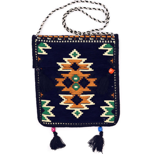 Dark navy kilim messenger bag with traditional Turkish handwoven patterns and rich, vibrant colours.