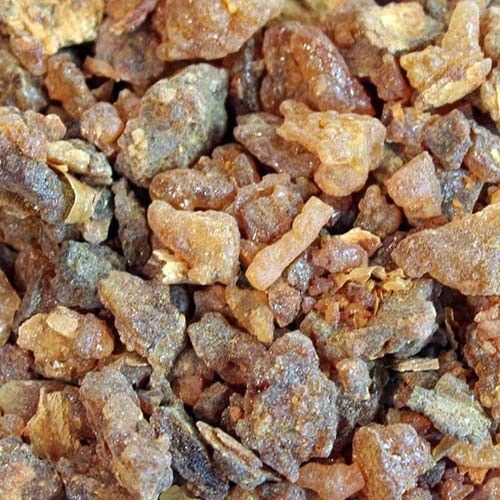 Golden brown Myrrh resin tears in a large heap, showing natural textures and varied aromatic pieces.