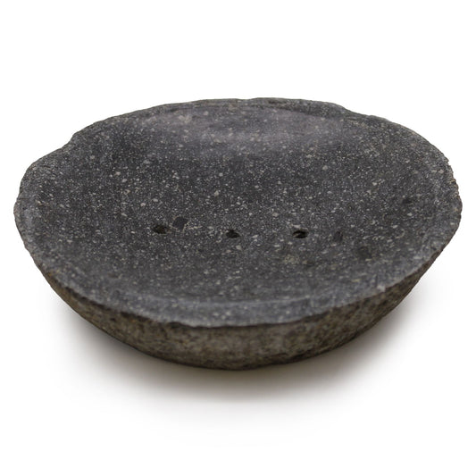 Handcrafted grey river stone soap dish with a polished surface, drainage holes, and raw organic edges.