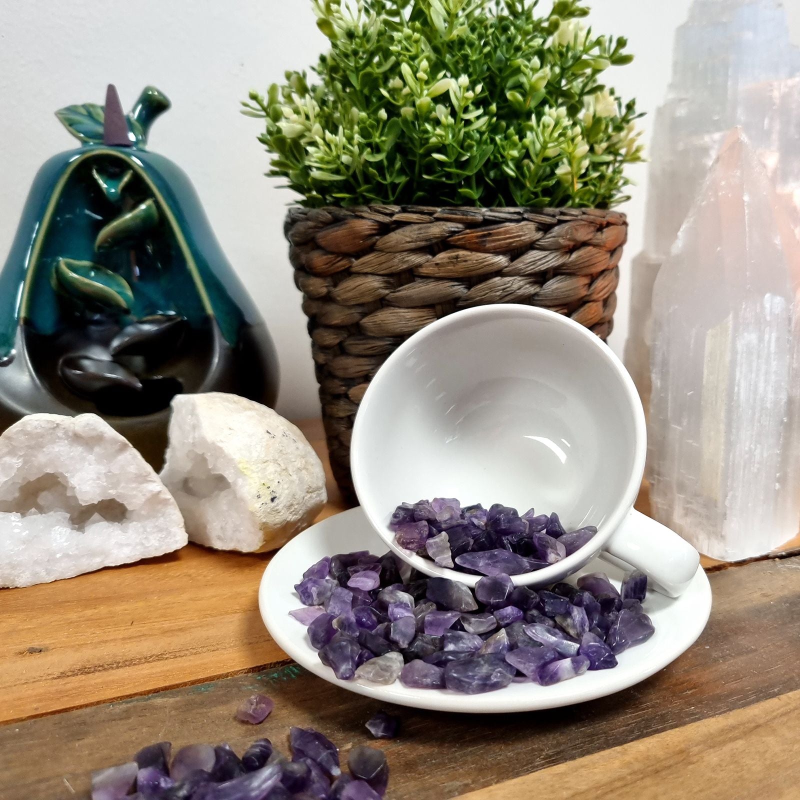 Large collection of small, tumbled green and white moss agate gemstone chips in a bulk pile.