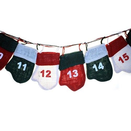Festive red and green elf mitten shaped pockets hanging on a string as a jute advent calendar decoration.