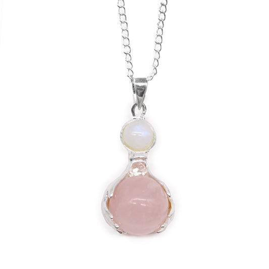 Delicate silver-tone healing hands cradling a polished pink rose quartz gemstone heart pendant.