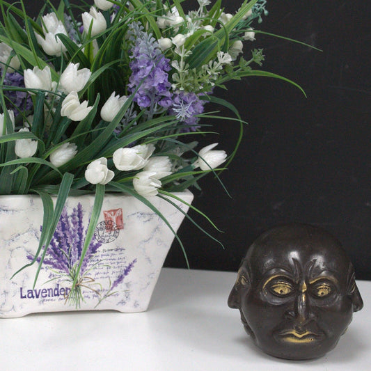 Small polished brass statue of a Four Face Buddha with intricate traditional detailing on a decorative base.