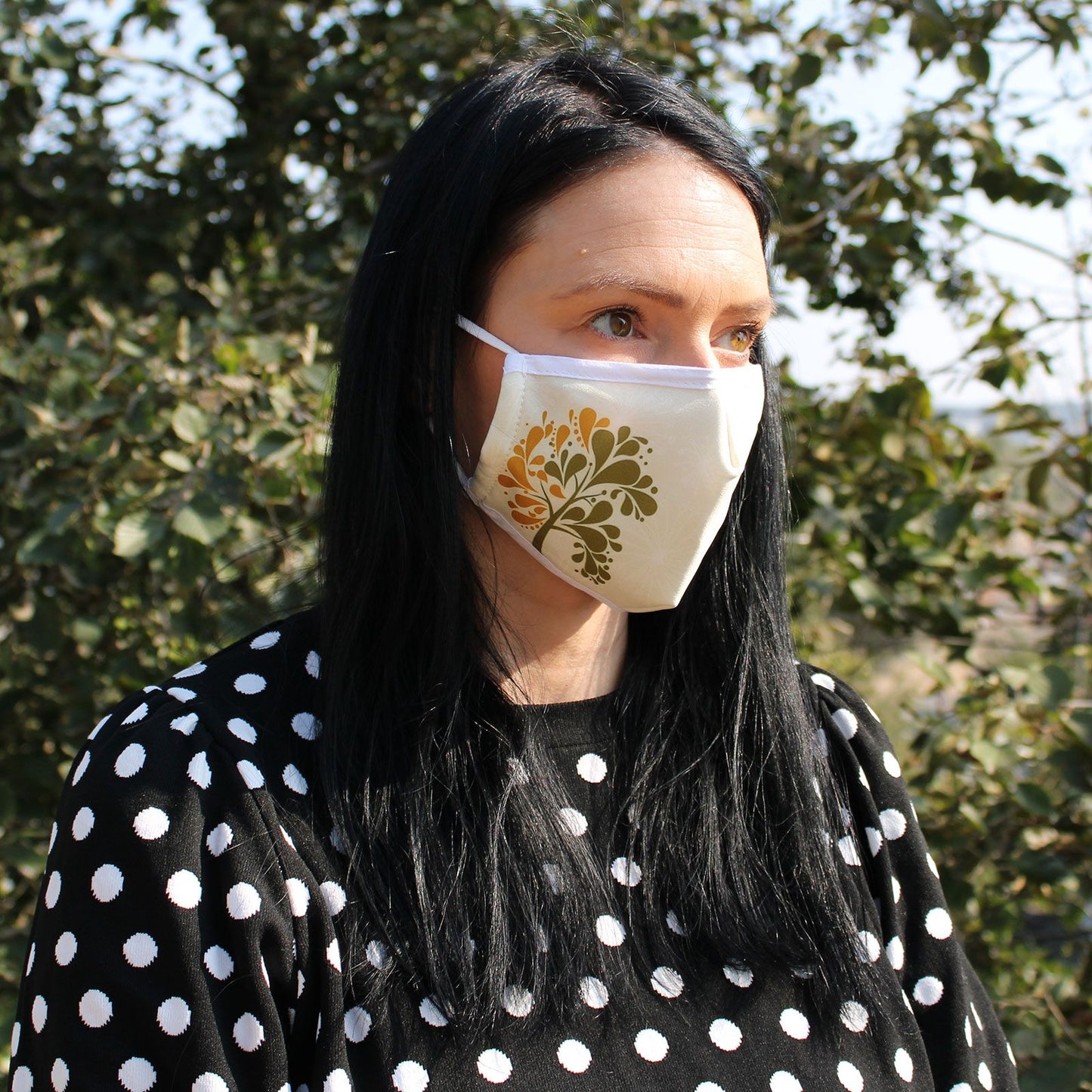 Adult-sized black fabric face covering featuring an elegant metallic gold tree of life pattern.