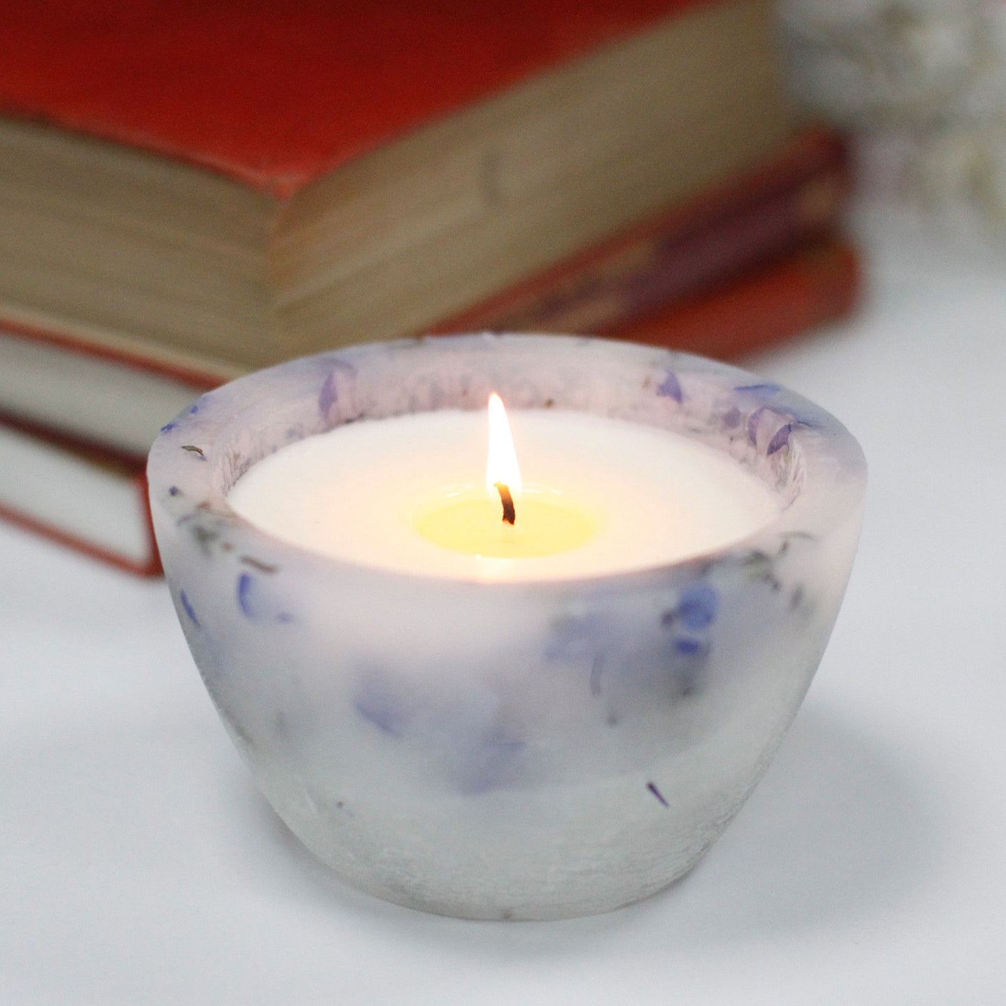 Large bowl candle with embedded dried lavender flowers that glows beautifully when lit.