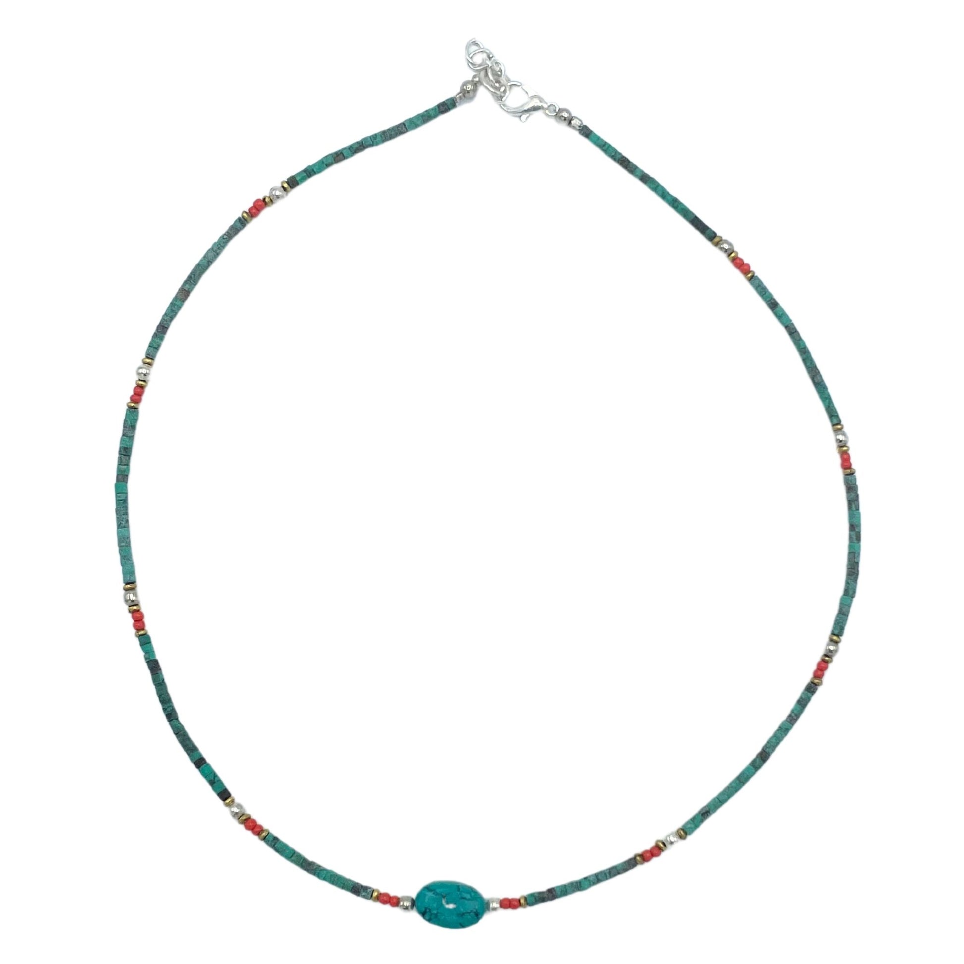 Intricate Nepalese gem necklace featuring vibrant turquoise beads and large polished stone accents on a delicate cord.
