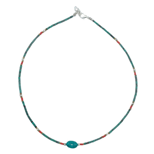 Intricate Nepalese gem necklace featuring vibrant turquoise beads and large polished stone accents on a delicate cord.