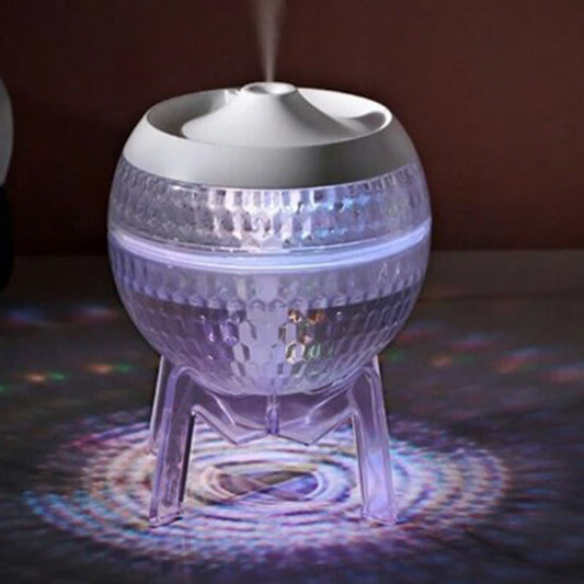Modern transparent sphere humidifier with a clear base and internal mechanism glowing with a warm white light.