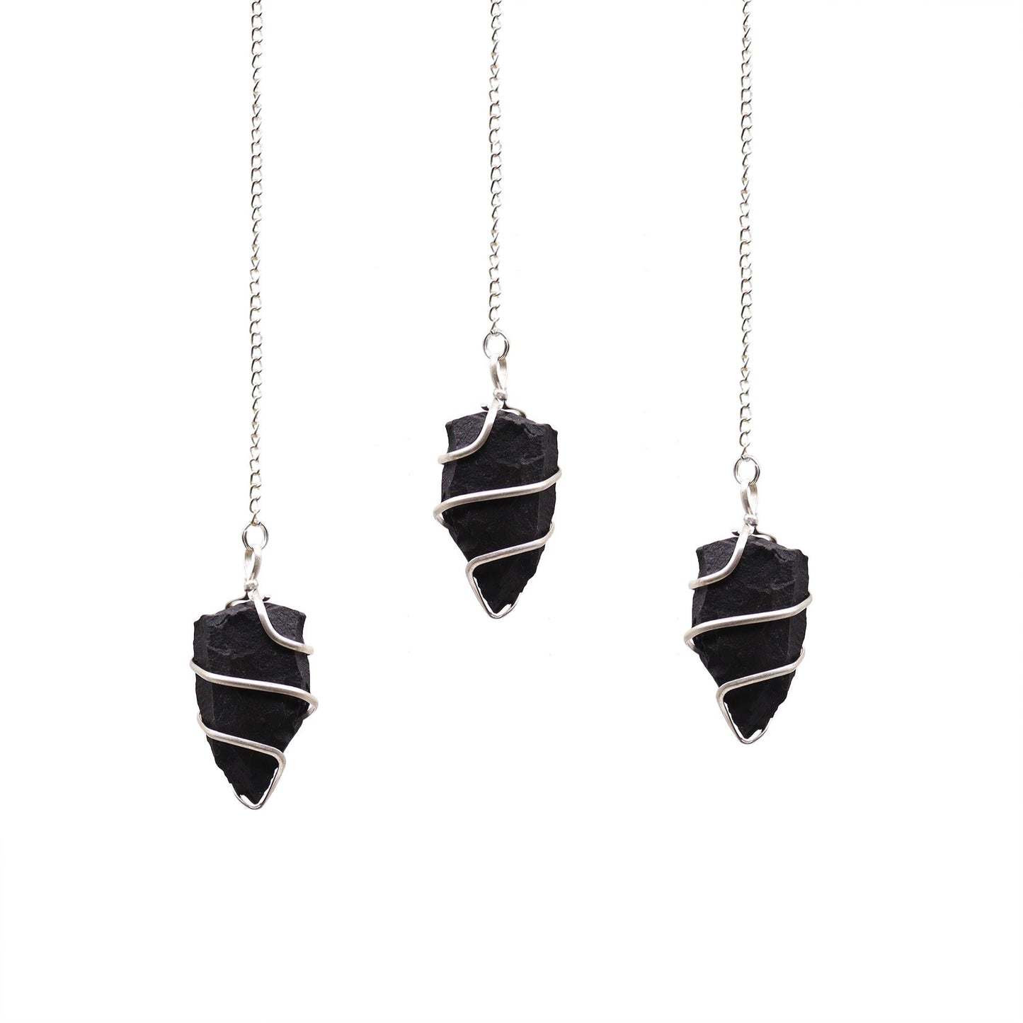 Raw black agate gemstone pendulum with a natural jagged texture suspended from a silver-toned chain.