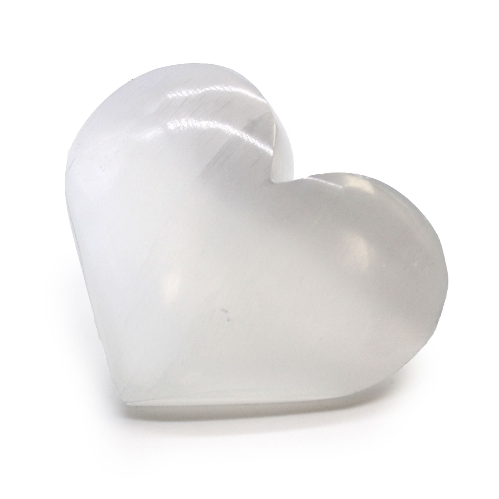 Small polished white selenite crystal carved into a smooth heart shape with a natural lunar glow.