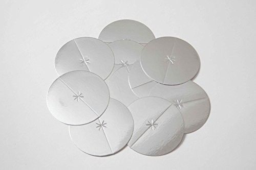 Circular silver protective discs for ear candles designed to catch residue during holistic ear wax treatments.