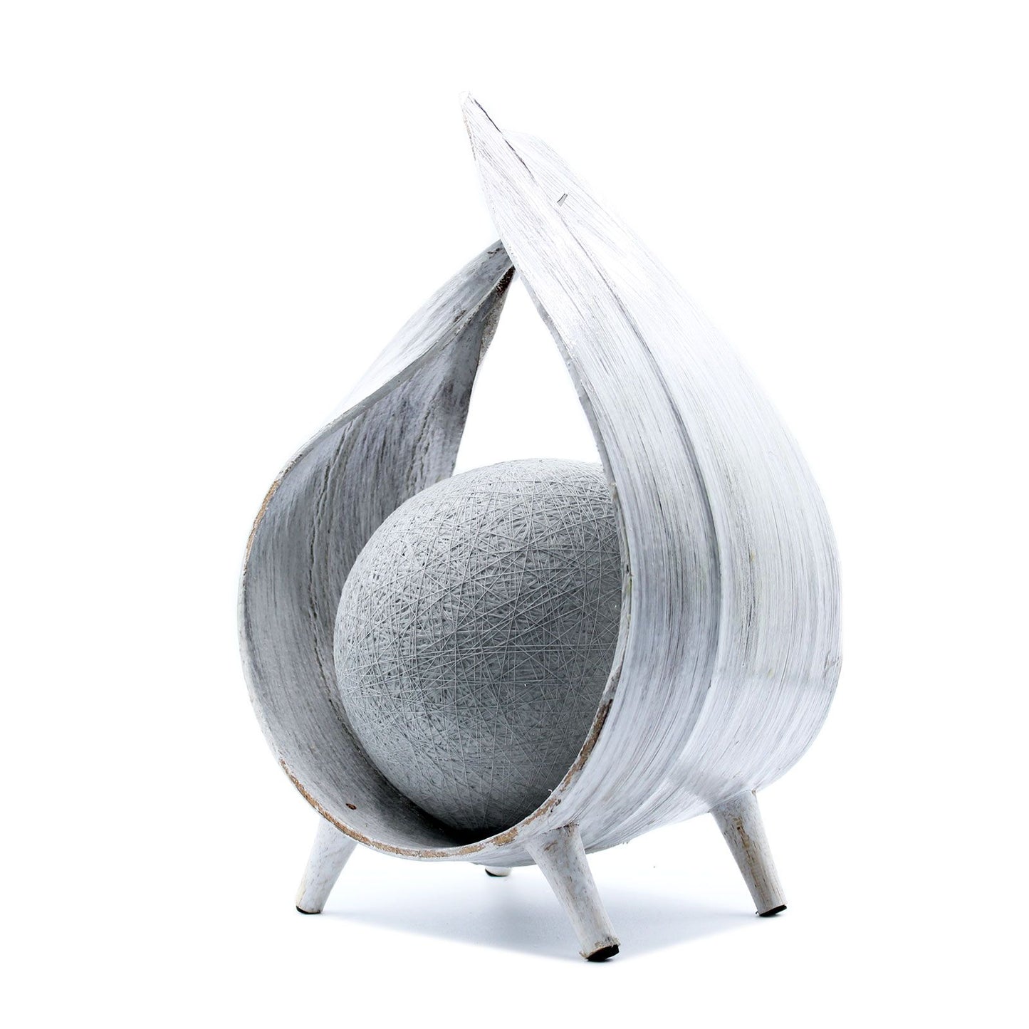 Handcrafted coconut shell lamp with a whitewashed finish and a unique wrapover design creating soft ambient light.