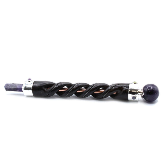 Intricate spiral carved healing wand featuring a purple amethyst crystal tip set in a copper pipe base.