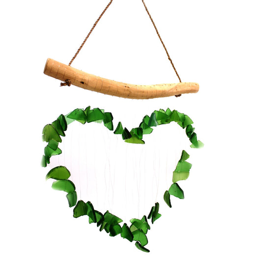 Heart-shaped green recycled glass wind chime hanging gracefully against a soft natural background.