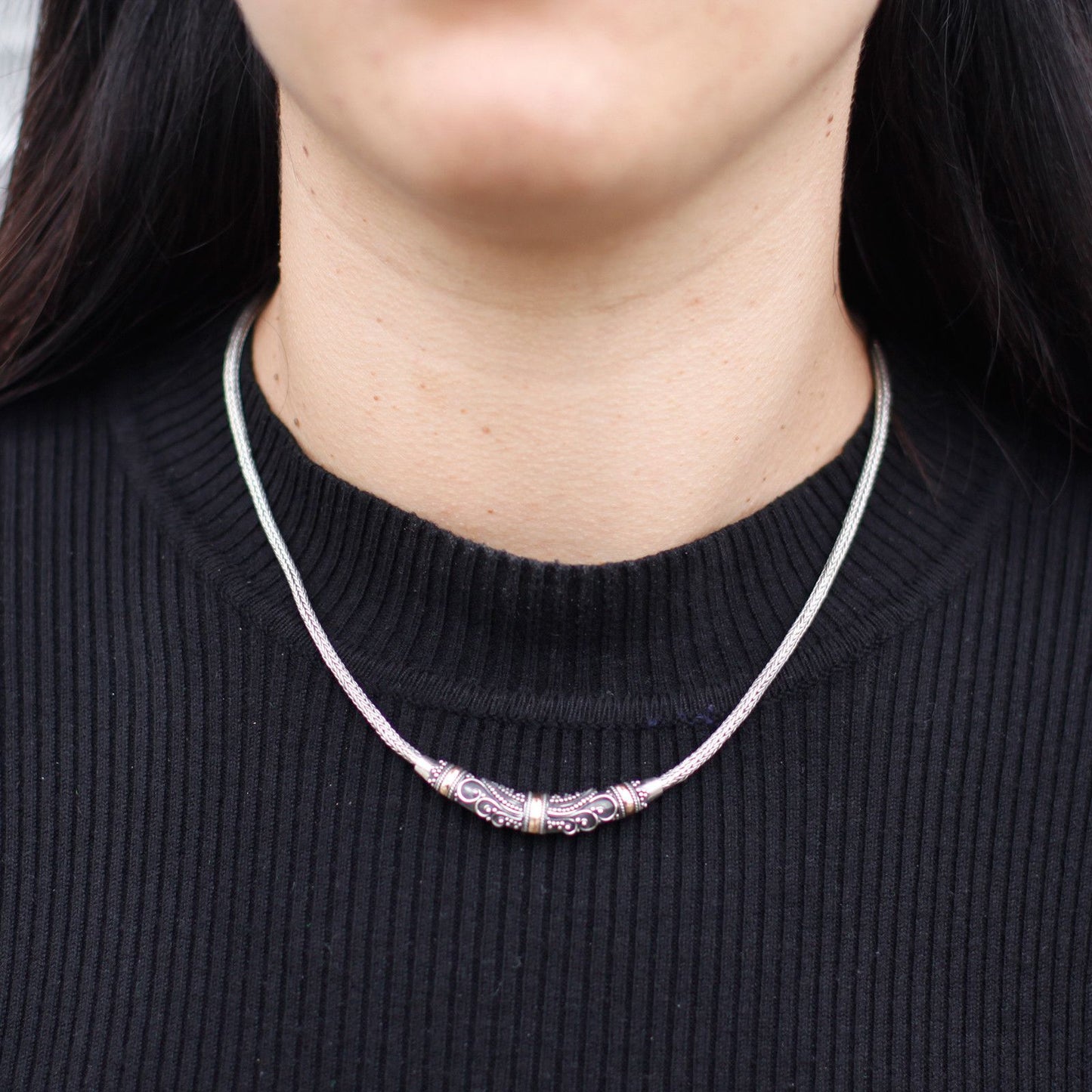 Elegant mixed metal necklace featuring a combination of silver and gold tribal-inspired elements on a delicate chain.