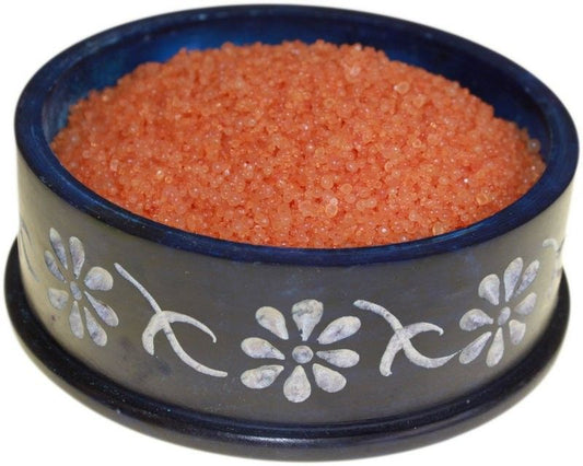 Small aromatic resinous simmering granules in a warm earthy tone for use in oil burners.
