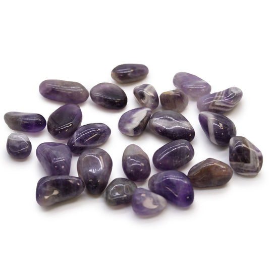 Several small, polished purple amethyst tumble stones showing varied shades of violet and natural quartz patterns.