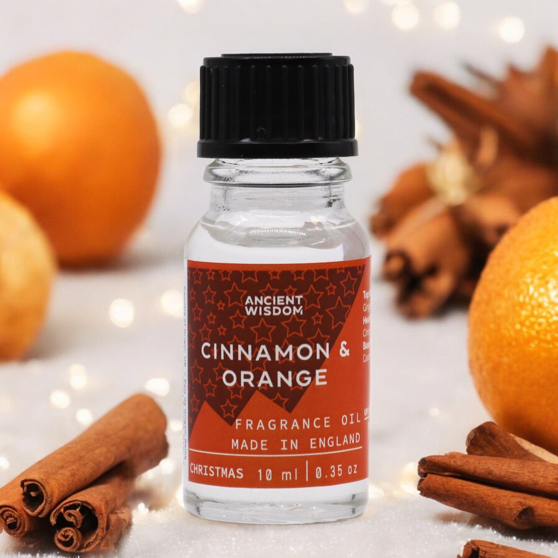 A 10ml amber glass bottle of Christmas themed cinnamon and orange fragrance oil with a black dropper cap.