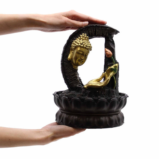 Serene 30cm golden Buddha sitting on a lotus flower within a decorative tabletop water fountain.