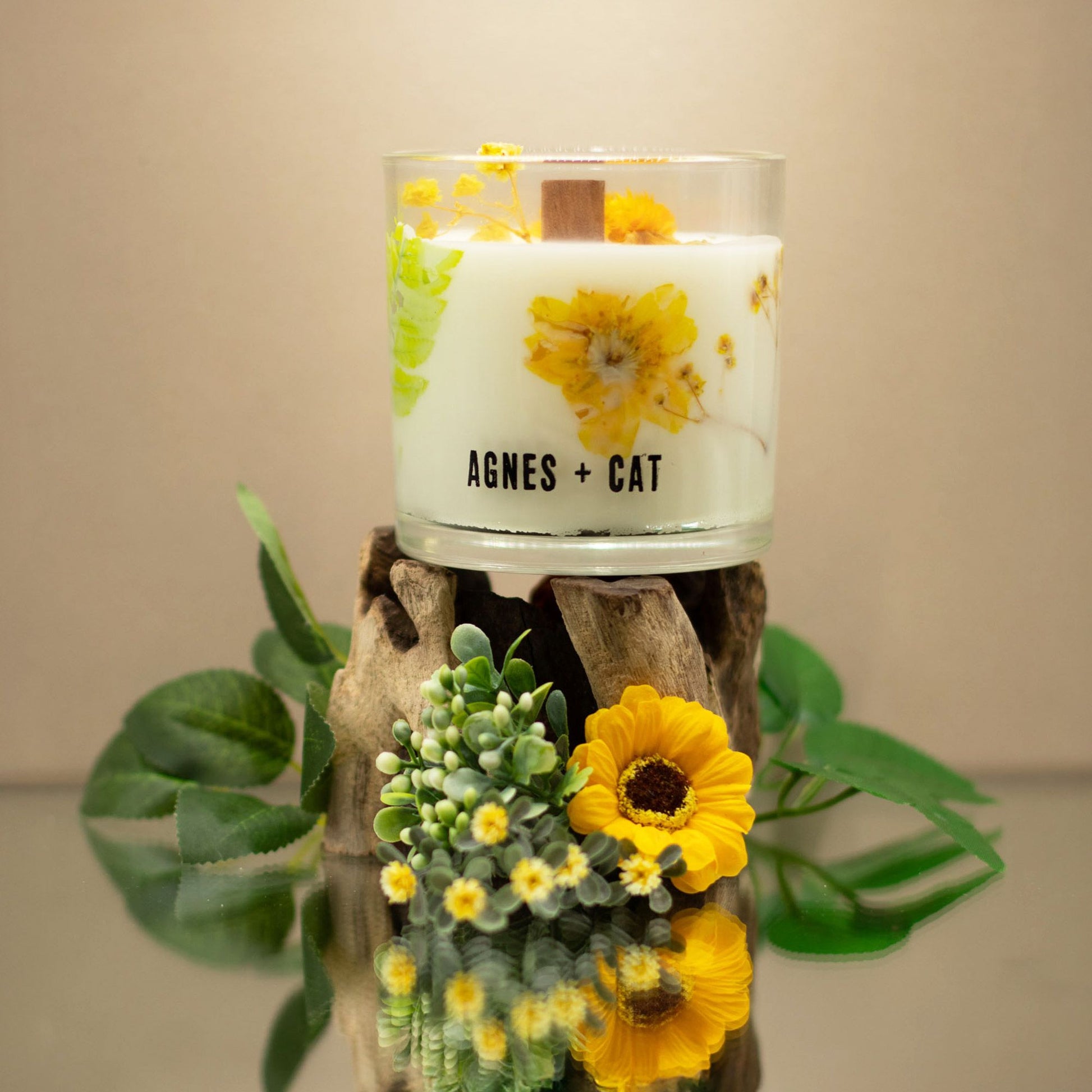 Handcrafted botanical soy wax candle decorated with real dried petals and featuring a deep oudh fragrance.
